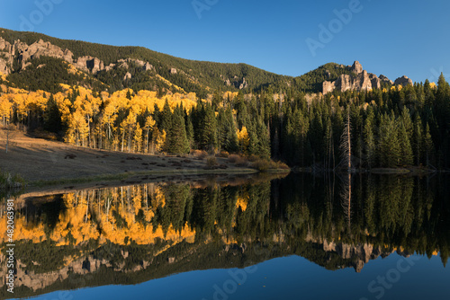 Reflections on Rowdy Lake, in the Cimarron Valley of Southwestern Colorado. The High Mesa Pinnacle rock formation is in the distance. 