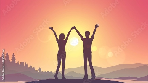 Silhouette of a couple of a woman and a man with raised hands on the background of nature and sunset