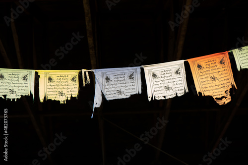 tattered and worn Tibetan prayer flags in closeup against a dark background © Diane N. Ennis