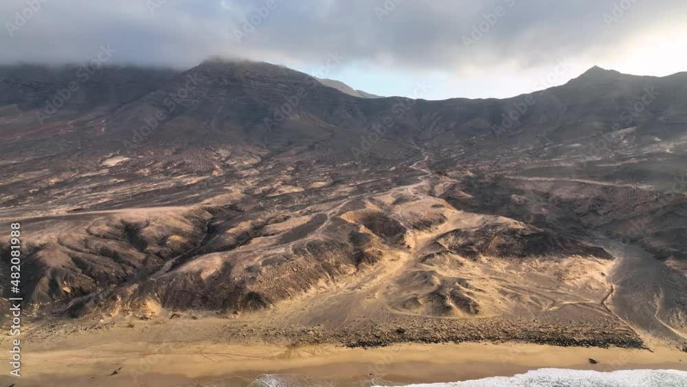 Playa de Cofete. The most beautiful beach of Fuerteventura Island. Canary Islands. Spain. Drone video. Aerial view of the beach. Atlantic ocean seaside. Winter seaside seascape. Playa de Cofete. The most beautiful beach of Fuerteventura Island. Canary Islands. Spain. Drone video. Aerial view of the beach. Atlantic ocean seaside. Winter seaside seascape.