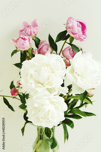 Fototapeta Naklejka Na Ścianę i Meble -  Sloopy flower bouquet of pink and white peonies flowers over pastel background, spring and summer