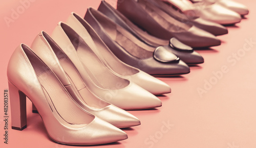 Fashionable women shoes isolated on pink background. View from above. Shoe for women. Stylish classic women leather shoe. High heel women shoes on red background photo