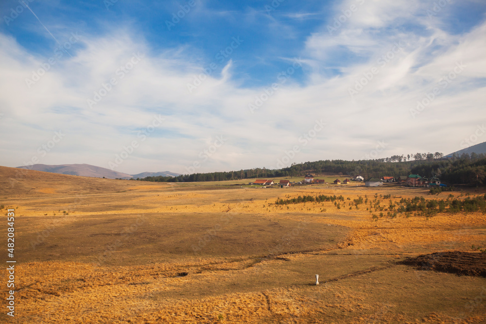 Beautiful nature landscape, autumn colors. View on hills and fields. Amazing nature of Serbia. Blue sky with clouds.