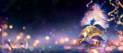 Carnival Party - Venetian Mask With Abstract Defocused Bokeh Lights On Shiny Streamers - Masquerade Disguise Concept photo