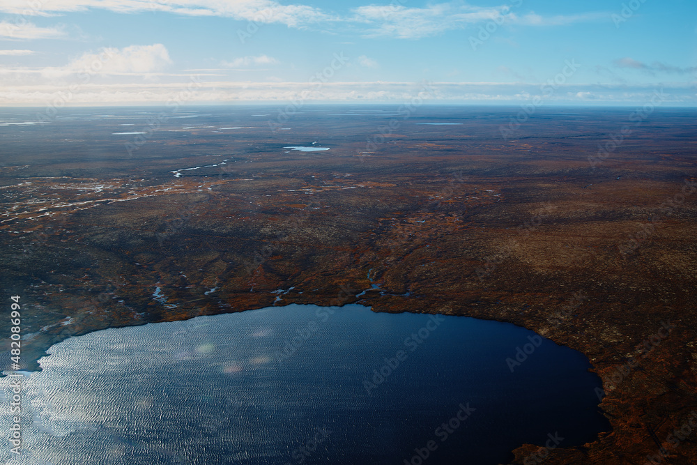 Aerial view and top view of the river in the tundra on the Taimyr Peninsula in Russia. Beautiful natural background. Blurred image, selective focus
