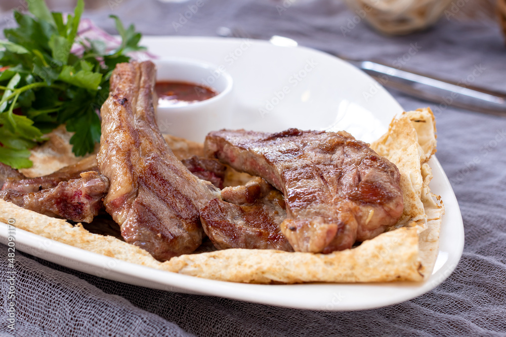 kebab from a rack of lamb on white plate kebab from a rack of lamb on white plate