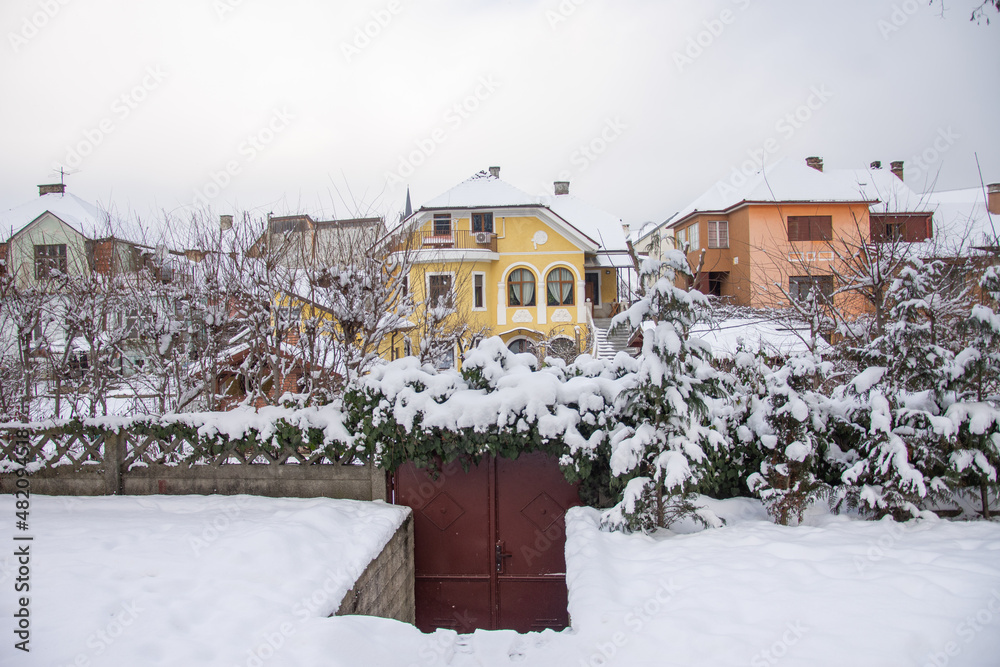 snow and houses in the park in January 2022, Romania Bistrita snow and houses in the park in January 2022, Romania Bistrita