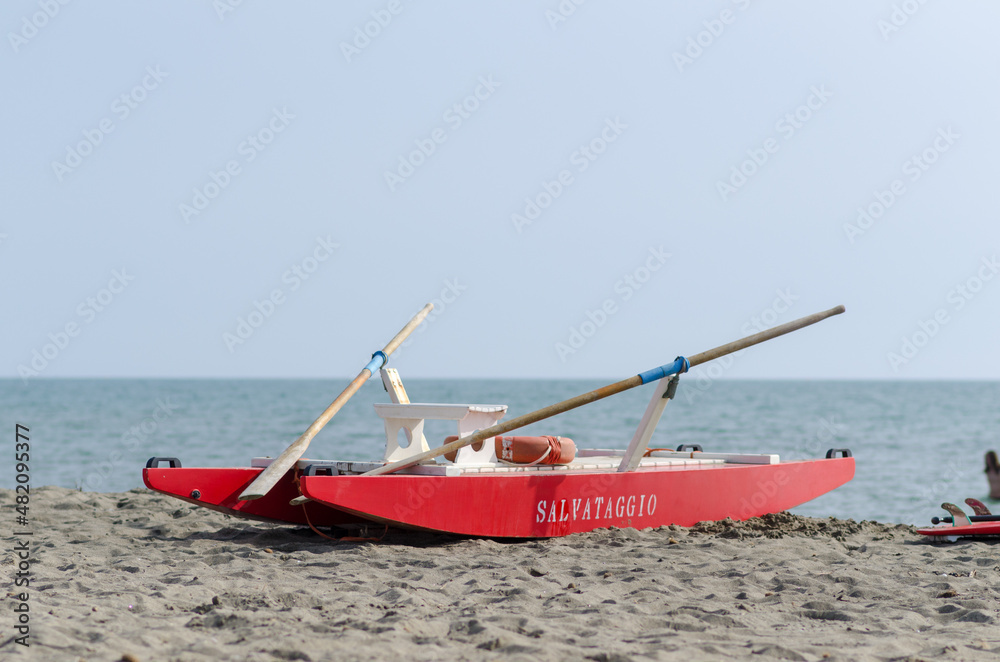 Lifeguard boat on the beach for emergencies, high visibility red colour. Sea beaches, coastal safety is constant, preventing the risk of accidents and shipwrecks. news,
