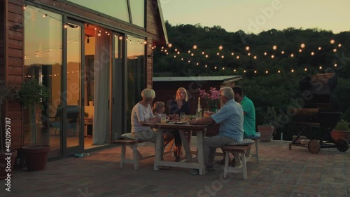 Affectionate family enjoying dinner during their get together in the backyard