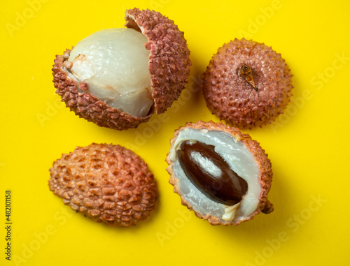 Sliced ​​lychee. Chinese plum.   Purified Lychee. Pieces of juicy fruit on a bright background.