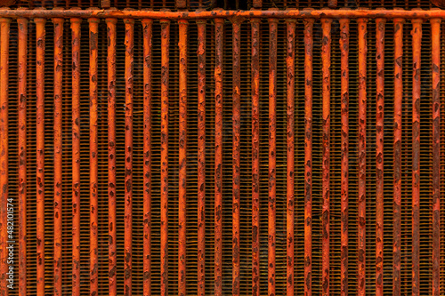 Close up of the front grille of an old heavy equipment tractor, a rural setting photo