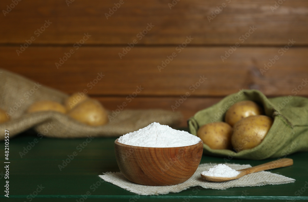 Starch and fresh raw potatoes on green wooden table. Space for text Starch and fresh raw potatoes on green wooden table. Space for text