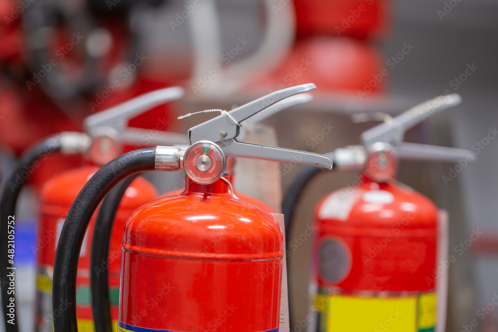The red fire extinguisher is in the building for fire prevention and safety. The red fire extinguisher is in the building for fire prevention and safety.