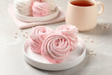 Delicious pink marshmallows on light grey table