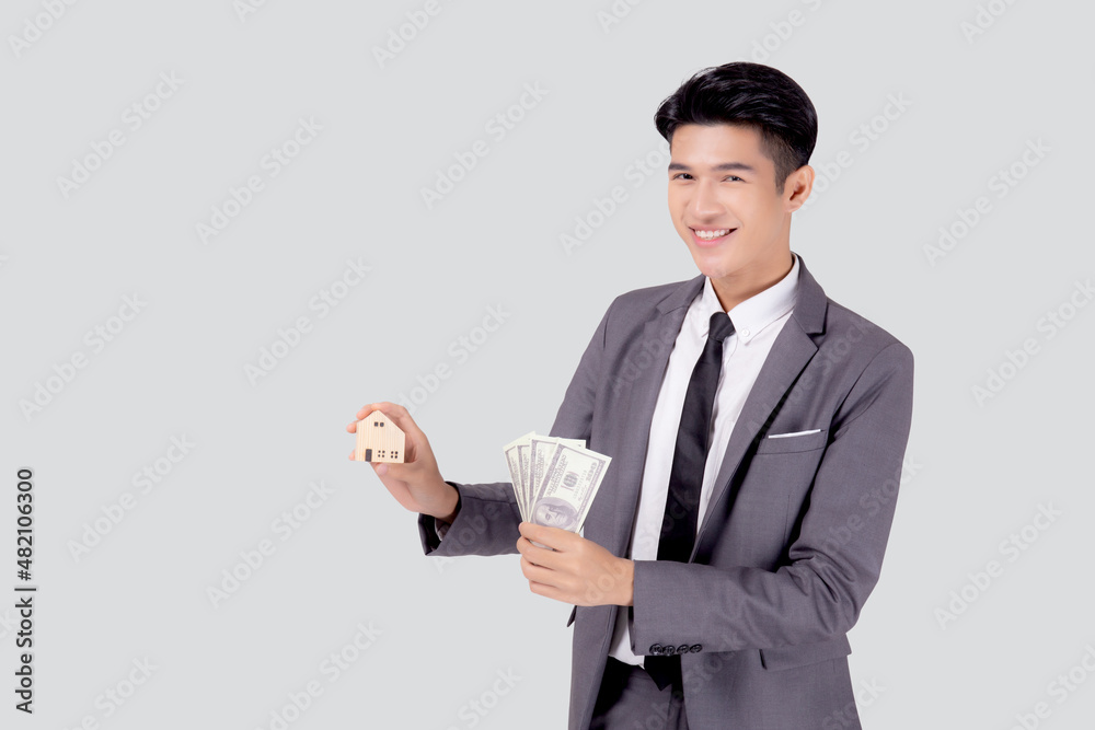 Young asian business man holding home and money dollar for saving for future, insurance agent and credit, debt and loan of finance, purchase home and refinance, investment about real property. Young asian business man holding home and money dollar for saving for future, insurance agent and credit, debt and loan of finance, purchase home and refinance, investment about real property.