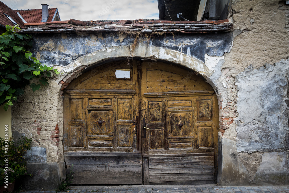Old entrance door, wooden gate, decayed, medieval style, made of ancient wood, still being used in front of a historical building in downtown zagreb, Croatia... Old entrance door, wooden gate, decayed, medieval style, made of ancient wood, still being used in front of a historical building in downtown zagreb, Croatia...