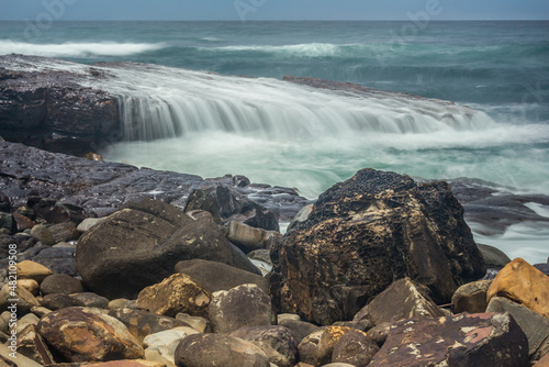 ocean wave cascade over rock shelf - long exposure © Libby