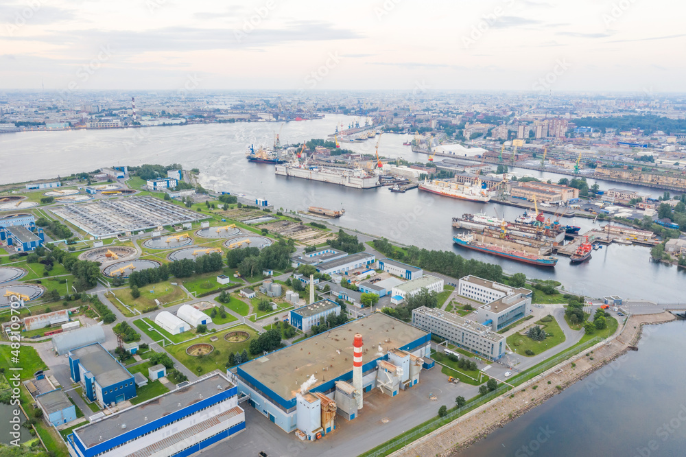 City sewage treatment plant on the island in the bay of the seaport aerial view.