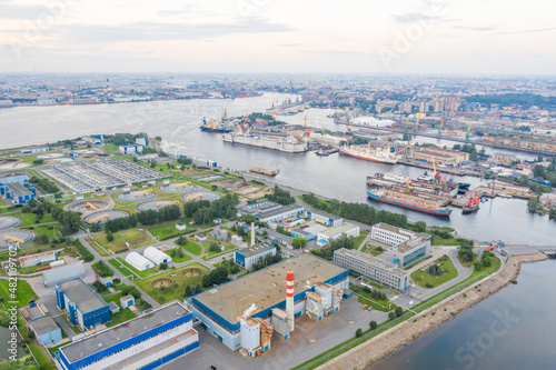 City sewage treatment plant on the island in the bay of the seaport aerial view. © aapsky