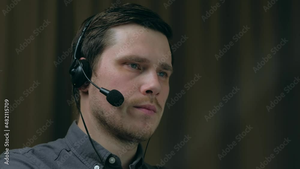 Close up portrait of Handsome man customer service representative working at evening in home or office. 4k. Technical support. Distant work pandemic concept. Close up portrait of Handsome man customer service representative working at evening in home or office. 4k. Technical support. Distant work pandemic concept.