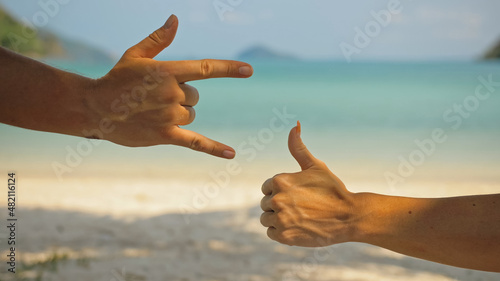 Hand shows the gesture class. A hand up showing rock sign. Young