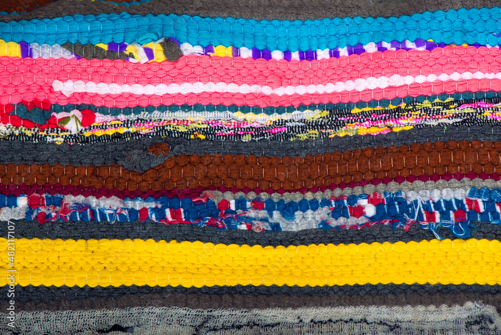 homemade rugs. close up of the braided multi colored woollen yarns homemade rugs. close up of the braided multi colored woollen yarns