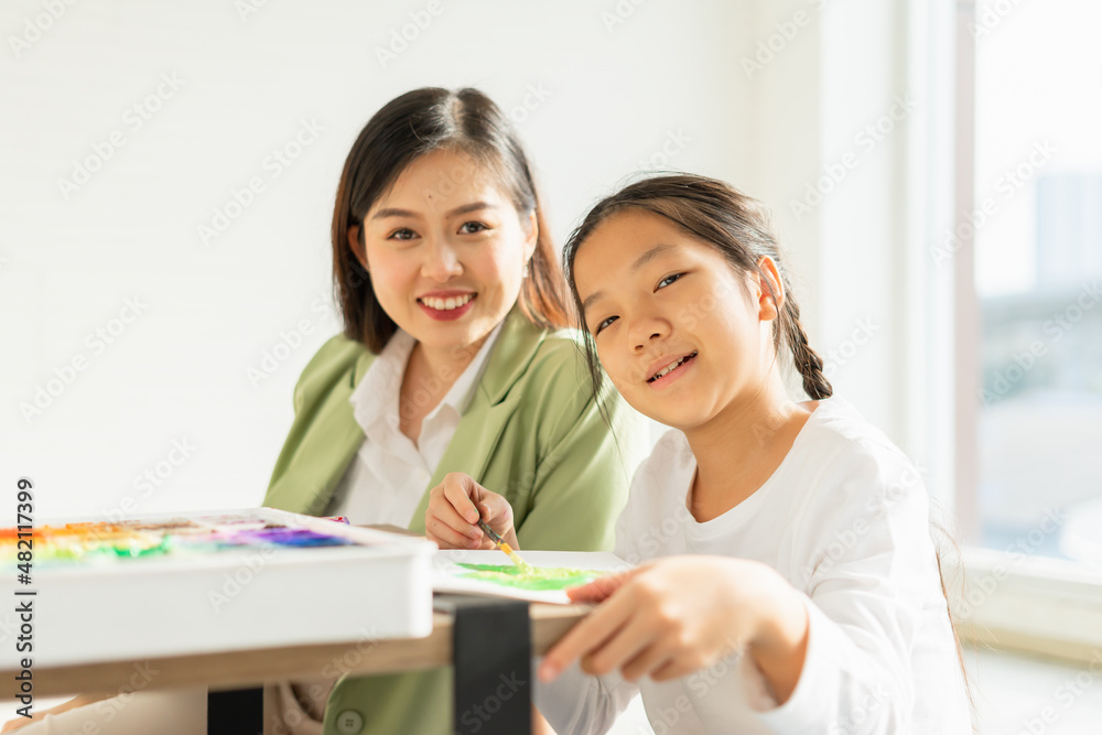 beautiful young children happy, smile, look at camera, fun painting color in education classroom, select focus at child. asian beautiful children happy and fun color painting education in small school beautiful young children happy, smile, look at camera, fun painting color in education classroom, select focus at child. asian beautiful children happy and fun color painting education in small school