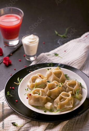 traditional Eastern dish manti or manty with beef in a dark