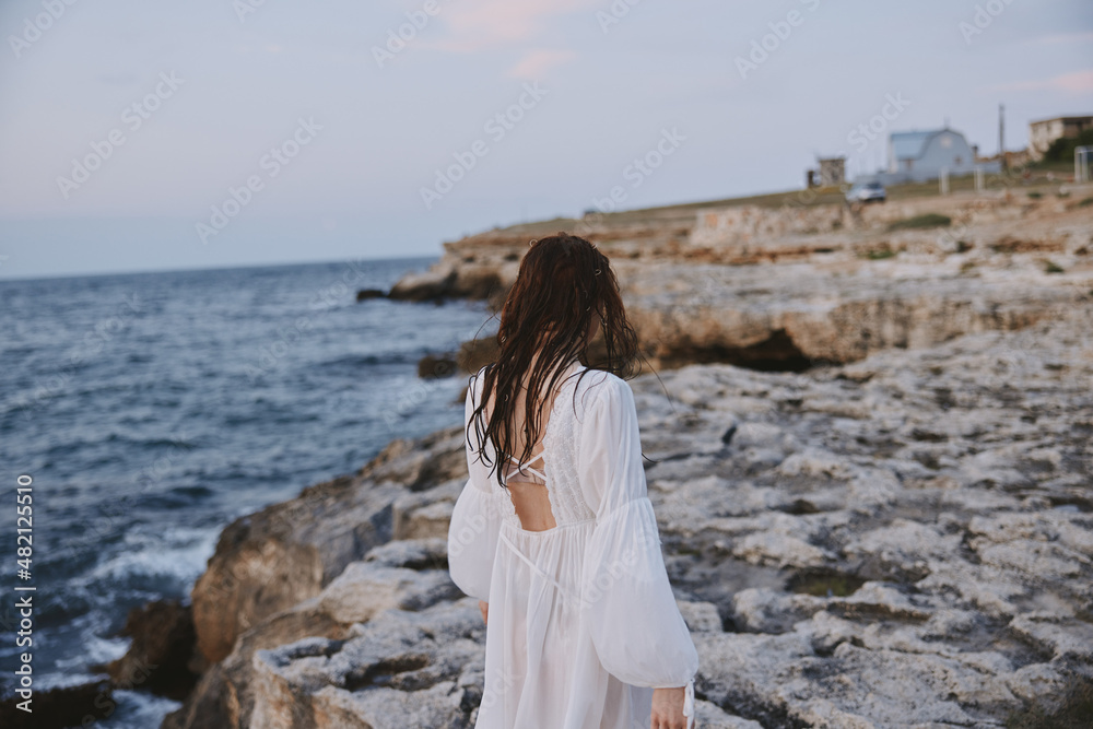 woman traveler enjoying for view of the beautiful sea on her holiday relax