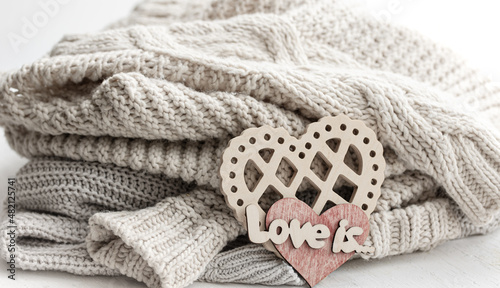 A decorative heart among cozy knitted items. Valentine s Day holiday concept.