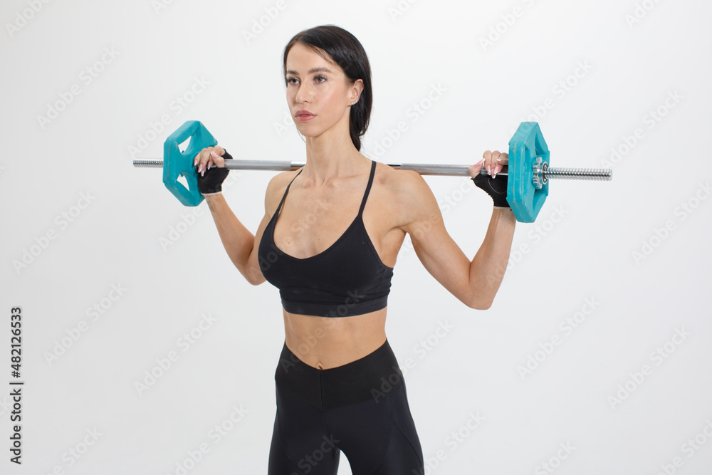 Obraz premium muscular fit woman with fitness barbell isolated on white background