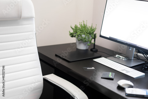 Comfortable modern workplace with computer and comfortable chair at home