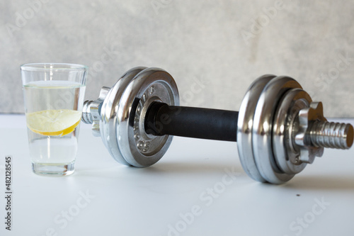 sport background in trendy color, with water bottle and dumbbells