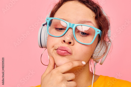 pretty woman yellow t-shirt headphones entertainment music fun pink background unaltered