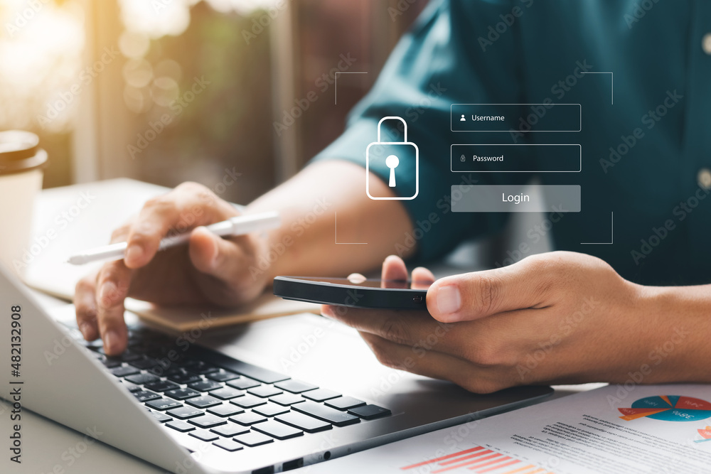 © Thapana_Studio - Cybersecurity internet and networking concept. Close up of hand holding smartphone information security and encryption, secure access to user's personal information, secure Internet access.