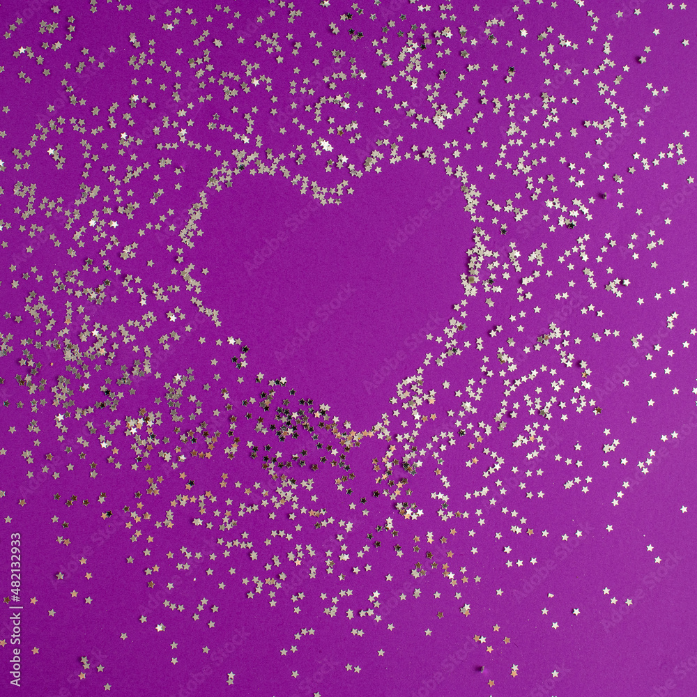 Creative heart shape made of shiny silver stars against purple background. Valentine's Day love concept. Flat lay.