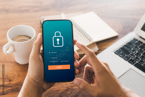 Cybersecurity internet and networking concept. Close up of hand holding smartphone information security and encryption, secure access to user's personal information, secure Internet access.