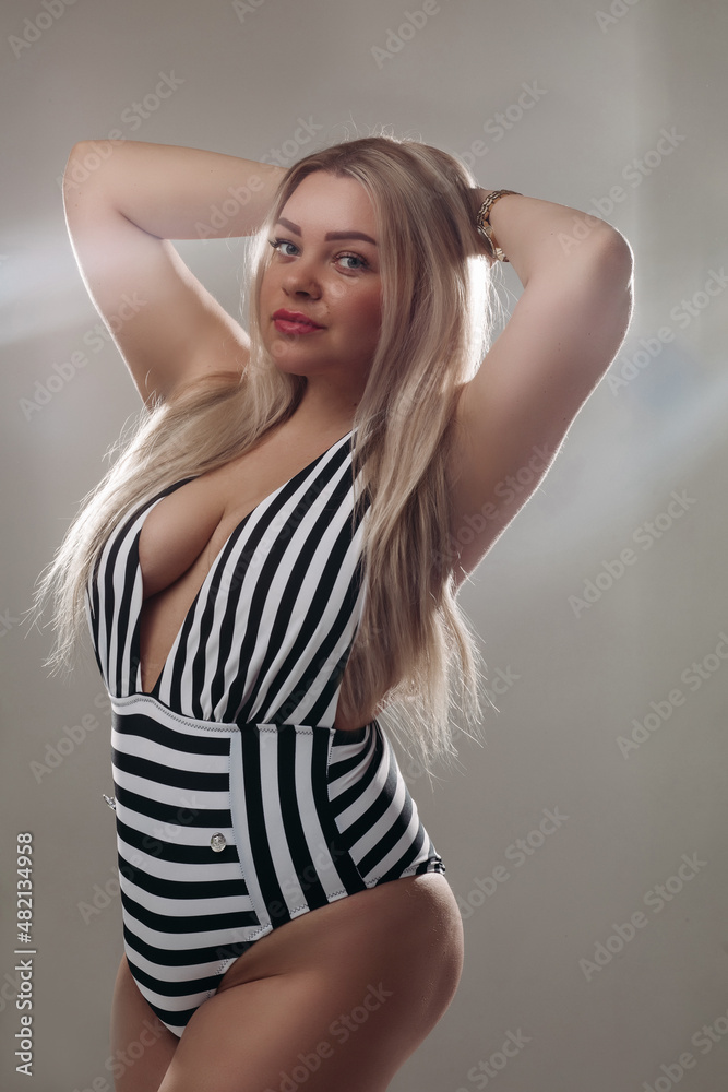 Fototapeta premium Attractive blonde woman wearing a black and white swimsuit