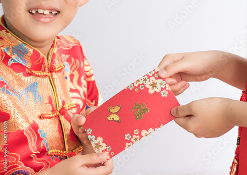Young boy happy to receive red pack on Chinese New year.  © Angkana