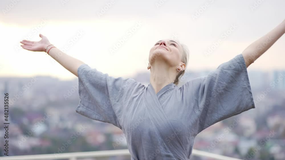 Portrait of smiling female coach yoga in robe makes Namaste gesture by hands Portrait of smiling female coach yoga in robe makes Namaste gesture by hands