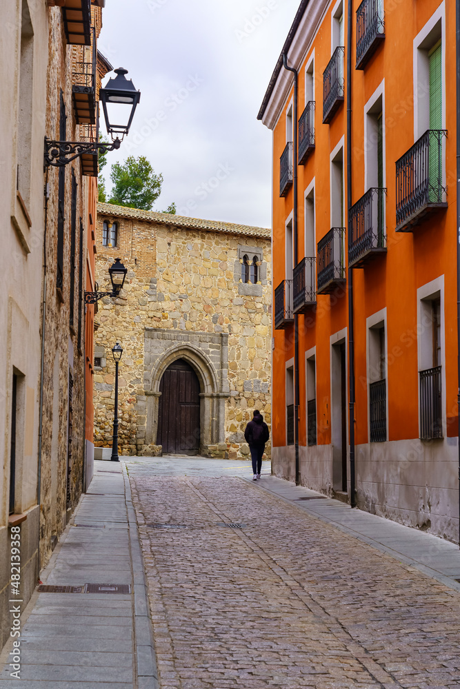 Alley with old houses with typical balconies in the medieval city of Avila, Spain.