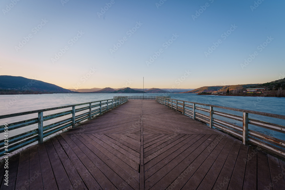 Empty deck walk background by the lake and clear sky in Salagou lake at dusk, France