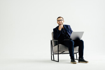 Pleasant positive business man using laptop on white background
