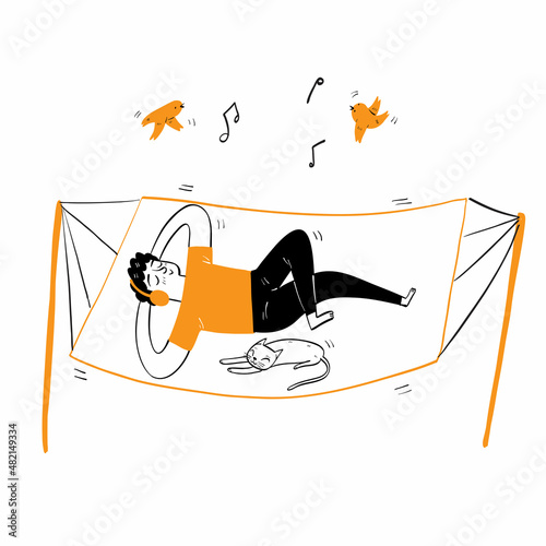 Happy man lying on the crib with headphones listening to music
