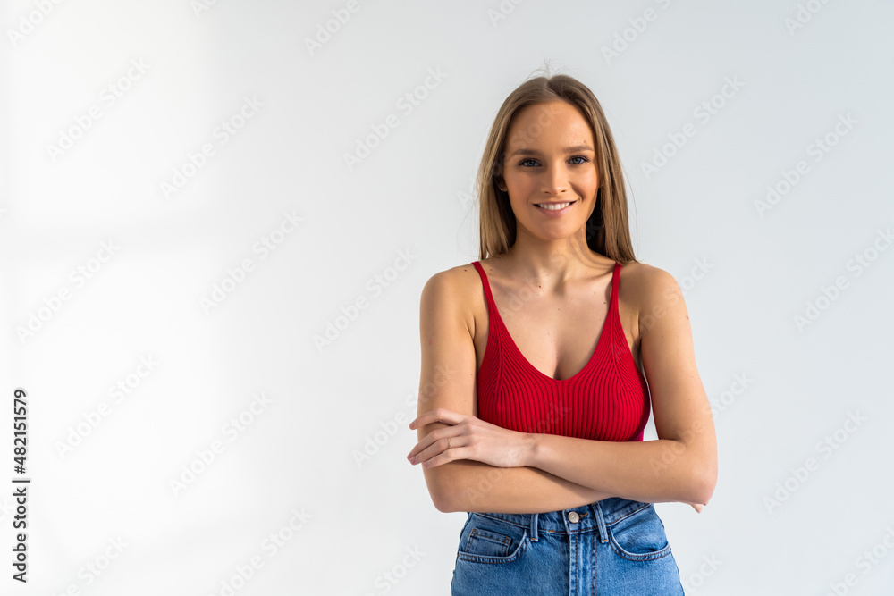 Portrait of a woman standing with arms folded isolated on a white background Portrait of a woman standing with arms folded isolated on a white background