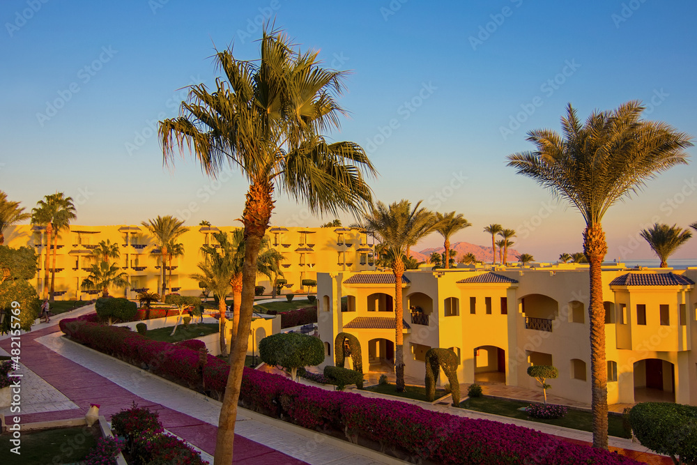 Sunset at luxury tropical resort on Red Sea coast in Sharm el Sheikh, South Sinai, Egypt, Africa. Dusk over Sharks Bay. Tourism and travel. Vacation and relax