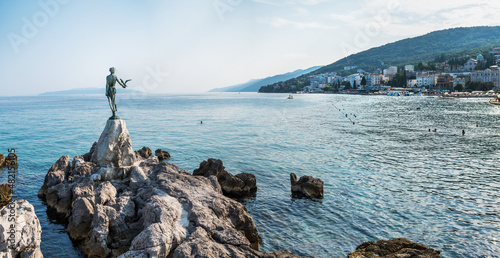 Fototapeta Naklejka Na Ścianę i Meble -  The Maiden with the Seagull. The statue is the symbol of  Opatij, Croatia. Beautiful panoramic view of Opatija town.
