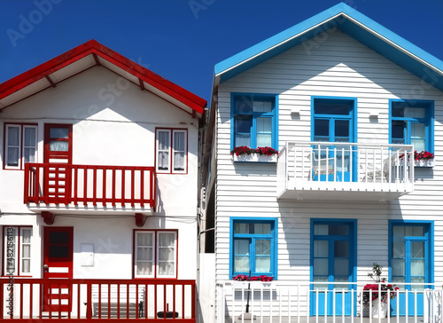 Colorful striped wooden beach houses at the promenade of Costa Nova, Aveiro, Portugal