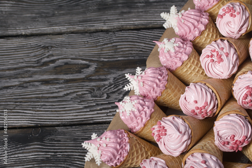 Zephyr in waffle cones. Decorated with decorative sprinkles and mastic snowflakes.