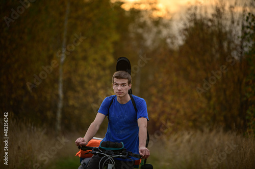 Handsome caucasian bicyclist in autumn forest